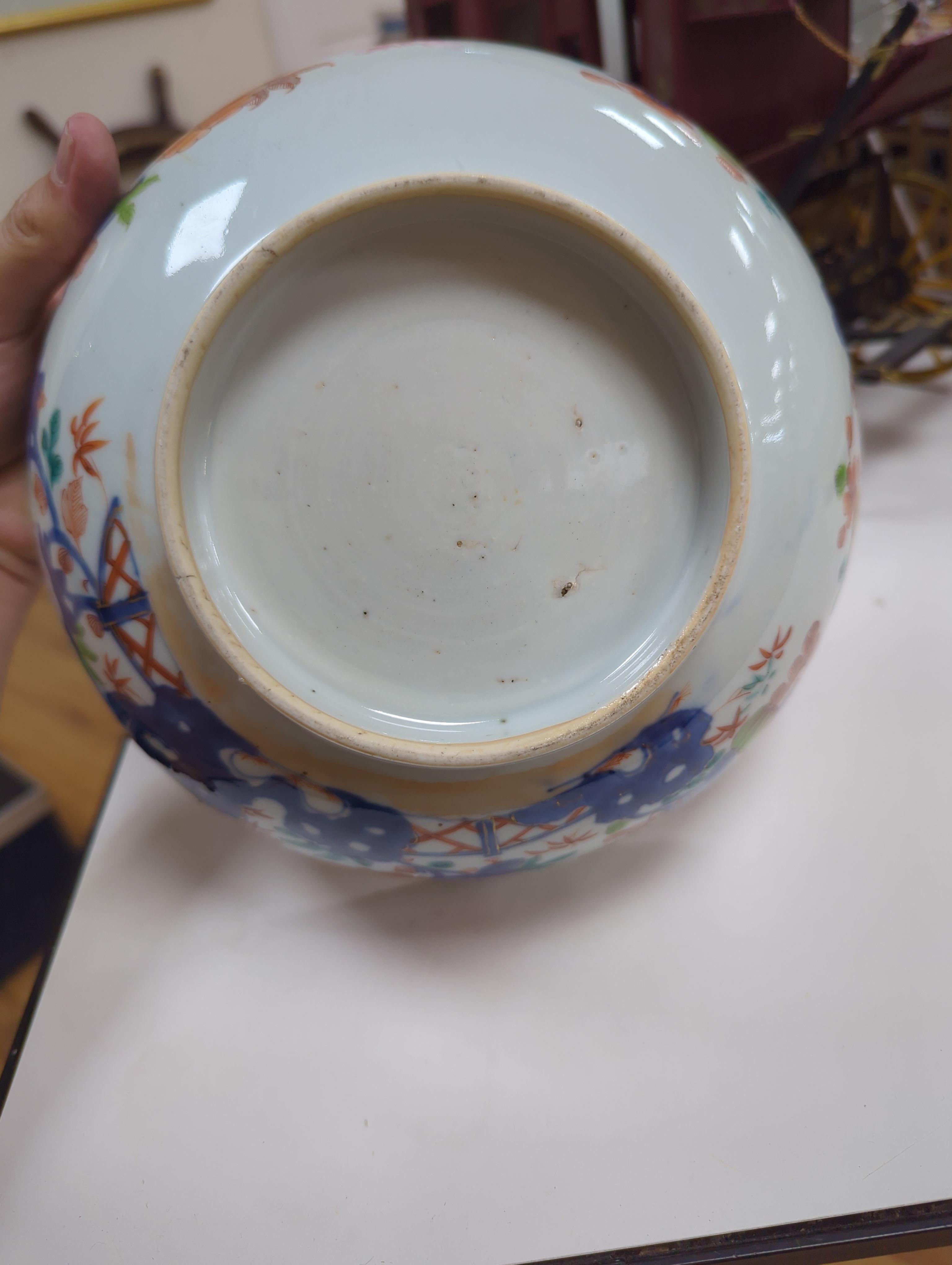 An 18th century Chinese famille rose bowl and a group of five Chinese wucai plates, each decorated with fruit, the bowl 23cm in diameter